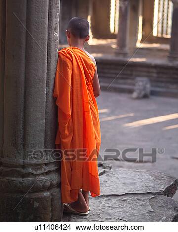 Picture - Back view of monks at Khmer Kingdom palace ruins. Fotosearch