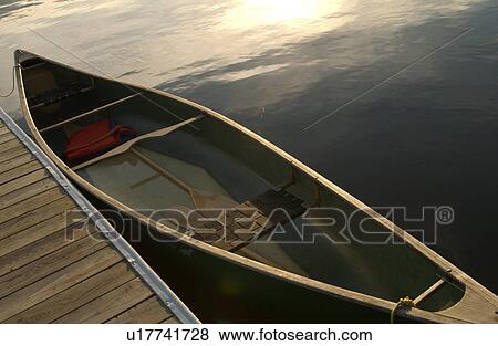 Canoe tied to a pier at Lake of the woods View Large Photo Image Stock Photo - Canoe tied to a pier at Lake of the woods. Fotosearch