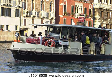 Stock Photo - Passenger boat in a canal in Venice, Italy. Fotosearch