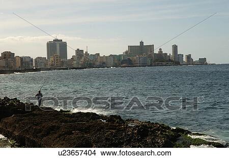 Person standing on rocks at the edge of the sea, Havana, Cuba View Large Photo Image Picture - Person standing on rocks at the edge of the sea, Havana, Cuba. Fotosearch