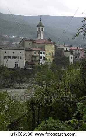 Stock Image - Residential buildings and a clock tower at a town in Slovenia. Fotosearch