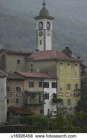 Residential buildings and a clock tower at a town in Slovenia View Large Photo Image Stock Photo - Residential buildings and a clock tower at a town in Slovenia. Fotosearch