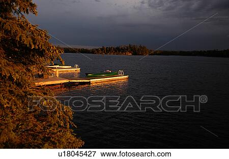 Rowboat parked at a pier View Large Photo Image Stock Photo - Rowboat parked at a pier. Fotosearch