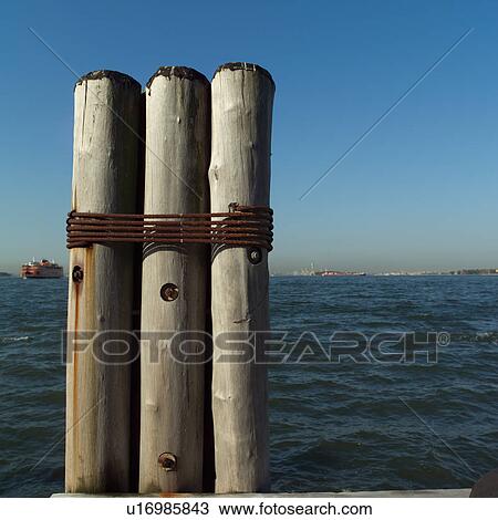 Three Posts tied together at Admiral Dewey Promenade, Battery Park, New York City View Large Photo Image Stock Image - Three Posts tied together at Admiral Dewey Promenade, Battery Park, New York City. Fotosearch