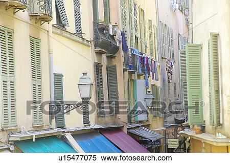 Stock Photography - Laundry hanging from balcony at apartment. Fotosearch
