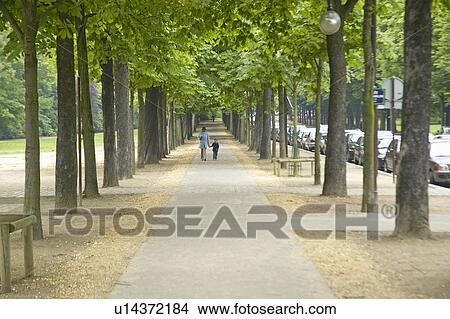 Picture - Mother and child walking through park, Paris, France. Fotosearch