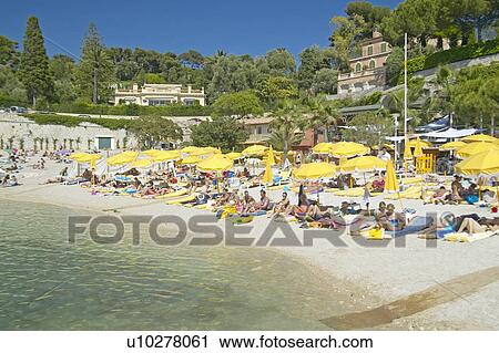 Sunbathers on beach on French Riviera, France View Large Photo Image Stock Image - Sunbathers on beach on French Riviera, France. Fotosearch