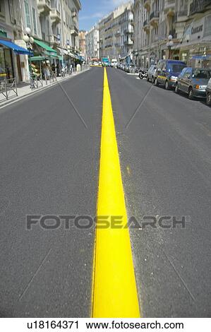 Stock Image - Yellow Line down center of road, Nice, France. Fotosearch