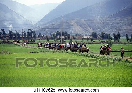 Stock Photography - Villagers escape traffic jam down side road in Dali, Yunnan Province, People's Republic of China. Fotosearch