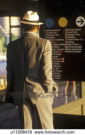 A business man stands waiting for a Metro rail View Large Photo Image Stock Photo - A business man stands waiting for a Metro rail. Fotosearch
