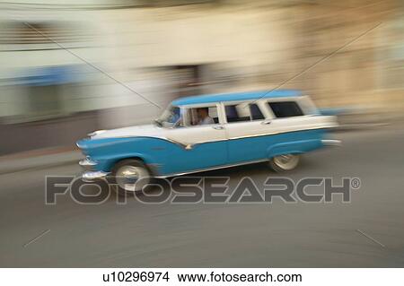 A speeding blue and white station wagon View Large Photo Image Picture - A speeding blue and white station wagon. Fotosearch