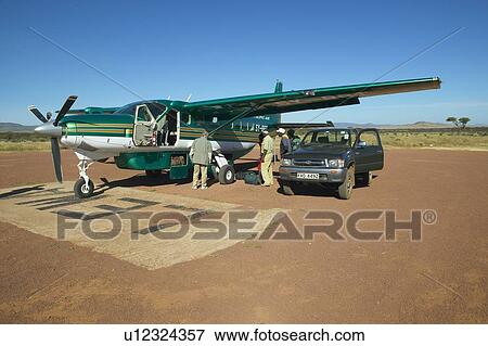 Airplane on landing strip, Africa View Large Photo Image Stock Photo - Airplane on landing strip, Africa. Fotosearch
