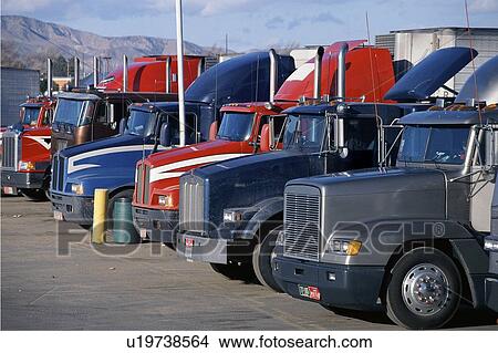 Big rig trucks in parked at truck stop View Large Photo Image Picture - Big rig trucks in parked at truck stop. Fotosearch