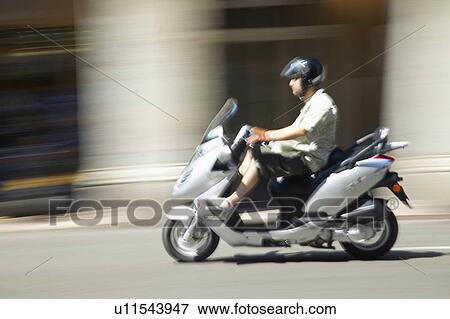 Man riding moped View Large Photo Image Stock Photo - Man riding moped. Fotosearch