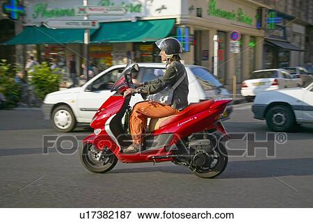 Stock Photo - Man riding moped. Fotosearch