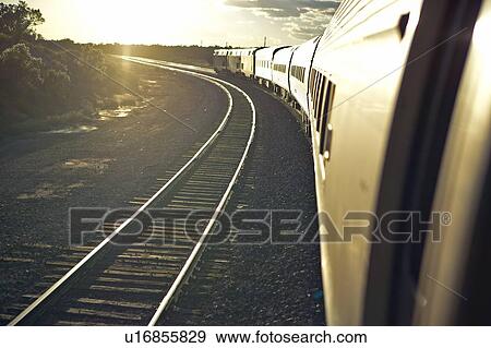 Passenger train traveling into the Arizona sunset View Large Photo Image Stock Photo - Passenger train traveling into the Arizona sunset. Fotosearch