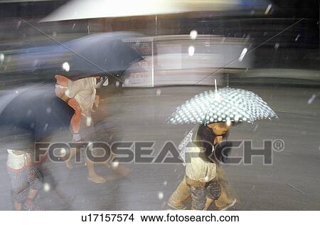 Walking in the rain in Dali, Yunnan Province, People's Republic of China View Large Photo Image Picture - Walking in the rain in Dali, Yunnan Province, People's Republic of China. Fotosearch