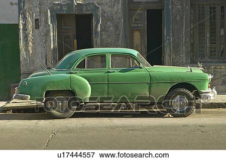 An old green car sitting in front of old building in Old Havana, Cuba View Large Photo Image Stock Photo - An old green car sitting in front of old building in Old Havana, Cuba. Fotosearch