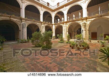 Stock Photograph - Centuries-old arches and courtyard of a colonial building in Havana. Fotosearch