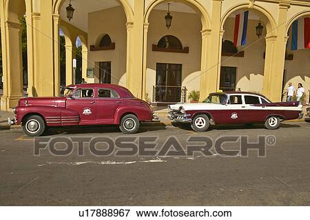 Classic old American cars parked in front of hotel in Old Havana View Large Photo Image Stock Photo - Classic old American cars parked in front of hotel in Old Havana. Fotosearch