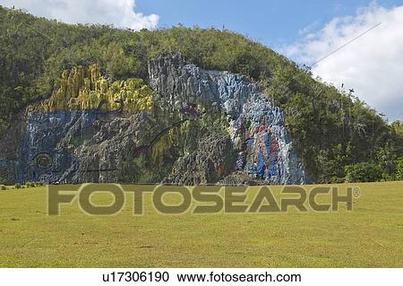 Stock Image - Detail of Mural de la Prehistoria commissioned by Che Guevara in the Valle de Vinales in central Cuba. Fotosearch