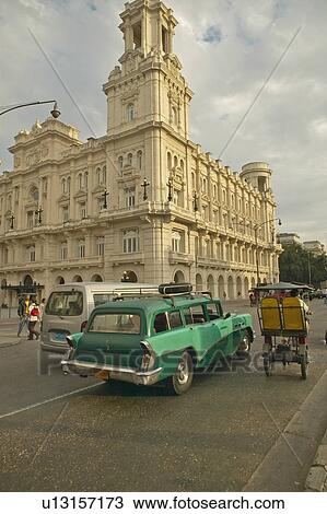 Turquoise 1955 Buick car and bicycle taxi driving the streets of Old Havana View Large Photo Image Stock Image - Turquoise 1955 Buick car and bicycle taxi driving the streets of Old Havana. Fotosearch