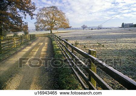 Morning view of a country road and wood fence in Upper Brails, England View Large Photo Image Stock Photography - Morning view of a country road and wood fence in Upper Brails, England. Fotosearch