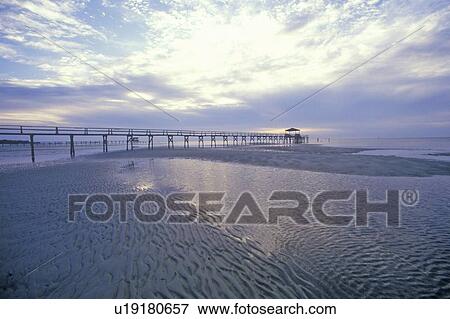Pier at sunrise over the Gulf of Mexico, Biloxi, MS View Large Photo Image Stock Photo - Pier at sunrise over the Gulf of Mexico, Biloxi, MS. Fotosearch