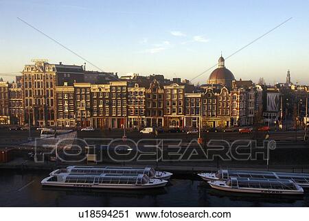 Stock Image - Sunrise over the town square in Amsterdam, Holland. Fotosearch