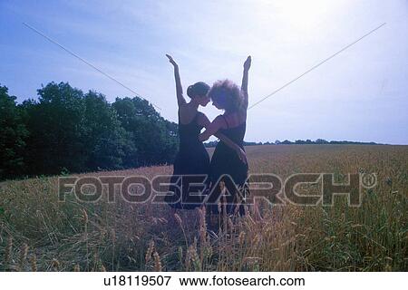 Two dancers posing outdoors in front of the sun View Large Photo Image Stock Photo - Two dancers posing outdoors in front of the sun. Fotosearch
