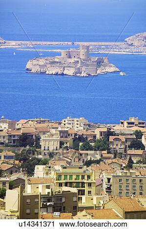 Stock Image - Aerial view of one of the Frioul islands, the Chateau d'If and the town of Marseilles. Fotosearch