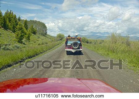 Bird watchers and red jeep in spring grasslands and mountains in Centennial Valley, Lakeview MT View Large Photo Image Stock Photography - Bird watchers and red jeep in spring grasslands and mountains in Centennial Valley, Lakeview MT. Fotosearch