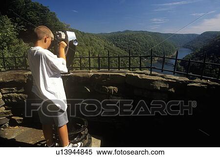 Boy tourist looking over Hawks Nest State Park View Large Photo Image Stock Photography - Boy tourist looking over Hawks Nest State Park. Fotosearch