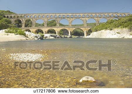 Stock Photograph - River Gard and the Pont du Gard, Nimes, France. Fotosearch