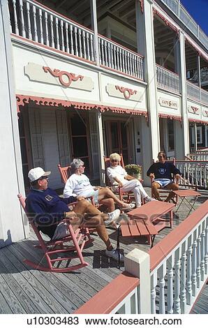 Tourists relaxing on a porch View Large Photo Image Stock Image - Tourists relaxing on a porch. Fotosearch