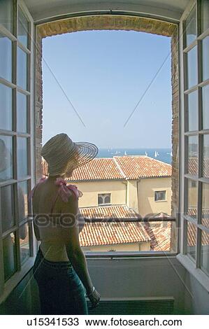 Woman looking out of window View Large Photo Image Stock Image - Woman looking out of window. Fotosearch