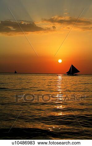 Stock Image - Beach at the sunset. Fotosearch