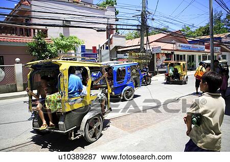 Stock Photo - The motorcycle carrying people running on the road. Fotosearch