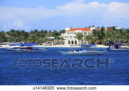 Stock Image - Tropical island under cloudy sky. Fotosearch