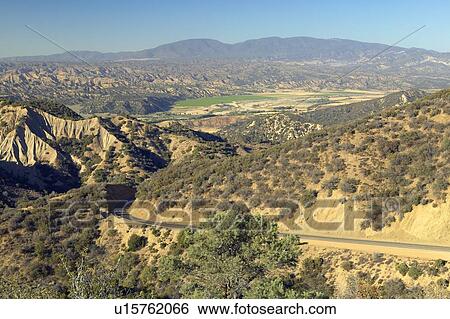 Stock Photograph - Highway 33 overview of Cuyama Valley with Green Field. Fotosearch