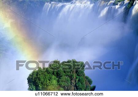 Rainbow over Iguazu Waterfalls in Parque Nacional Iguazu viewed from Upper Circuit, border of Brazil and Argentina View Large Photo Image Stock Image - Rainbow over Iguazu Waterfalls in Parque Nacional Iguazu viewed from Upper Circuit, border of Brazil and Argentina. Fotosearch