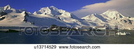Panoramic view of ecological tourists in inflatable boats, snowy mountains, glaciers and icebergs View Large Photo Image Stock Photo - Panoramic view of ecological tourists in inflatable boats, snowy mountains, glaciers and icebergs. Fotosearch