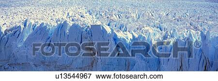 Stock Photo - Panoramic view of glacier melting as it falls into water. Fotosearch