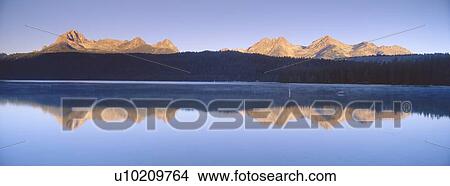 Sunrise over lake and mountains View Large Photo Image Picture - Sunrise over lake and mountains. Fotosearch