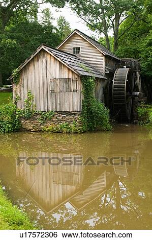 Stock Photograph - Historic Edwin B. Mabry Grist Mill (Mabry Mill) in rural Virginia on Blue Ridge Parkway and reflection on pond in summer. Fotosearch