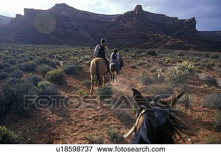 Horseback riding in Valley of the Gods View Large Photo Image Stock Photo - Horseback riding in Valley of the Gods. Fotosearch