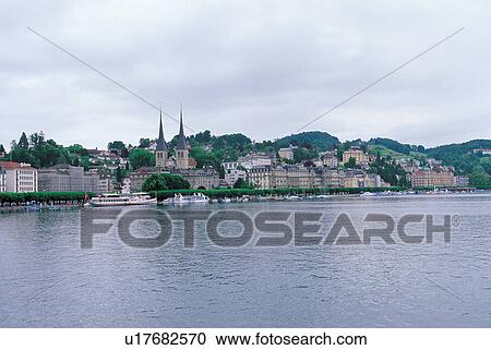 Stock Image - harbor, sea, buildings, houses, sailboat, day, clouds. Fotosearch