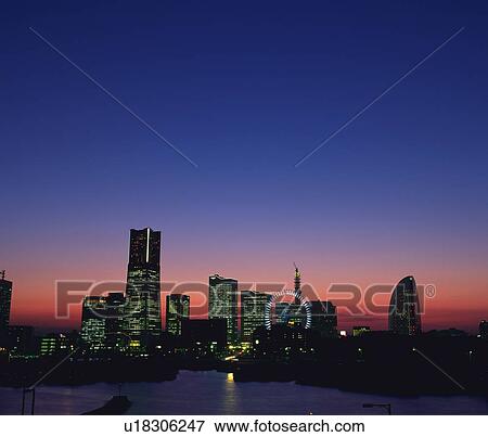 Stock Photo -  the Buildings of Sakuragicho Illuminated Bu Sunset, Front View, Far View, Yokohama City, Kanagawa Prefecture, Japan. Fotosearch