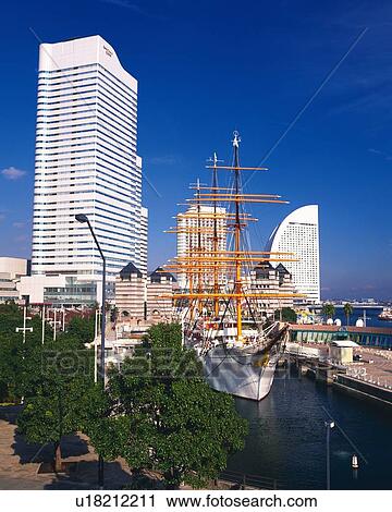 Stock Image -  the Nihonmaru at a Port, Among Several Trees, Buildings and Skyscrapers, Yokohama City, Kanagawa Prefecture, Japan. Fotosearch