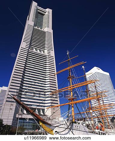Stock Photo -  the Nihonmaru Ship In Front of the Landmark Tower, Low Angle View, Yokohama City, Kanagawa Prefecture, Japan. Fotosearch